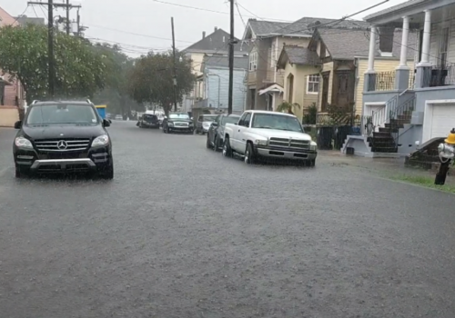 Flooded street with cars in it.